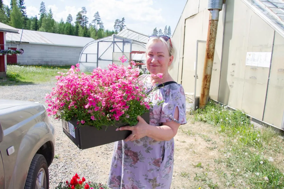 Asiakas kukkalaatikon kanssa